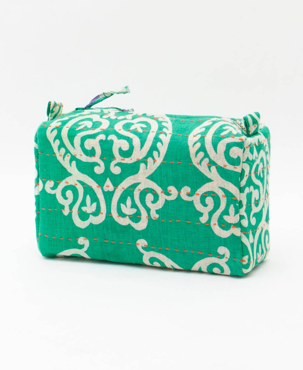 Green fabric pouch with white floral pattern on a white background