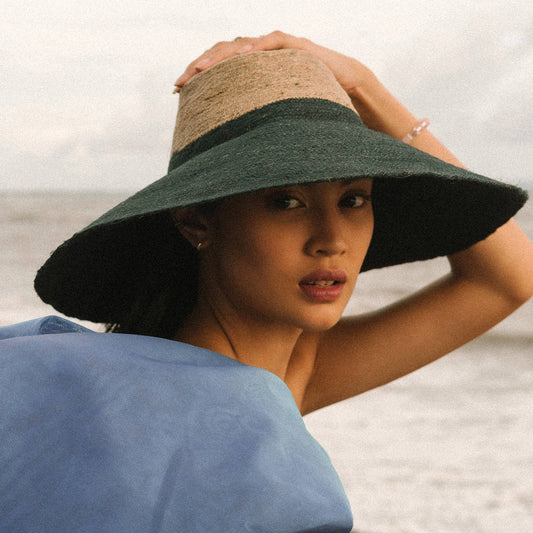 Woman wearing a wide-brimmed hat on a beach