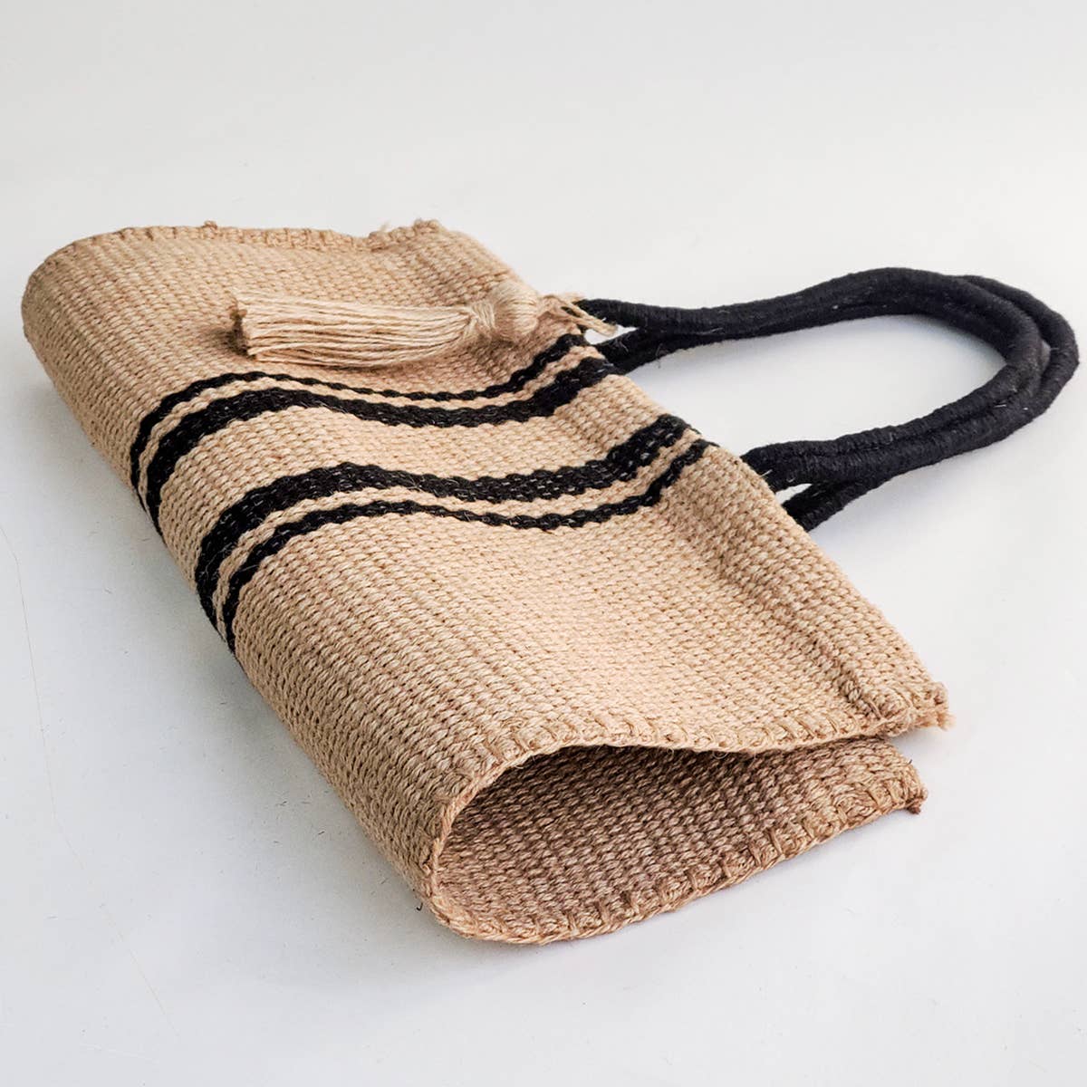Woven bag with black stripes on a white background