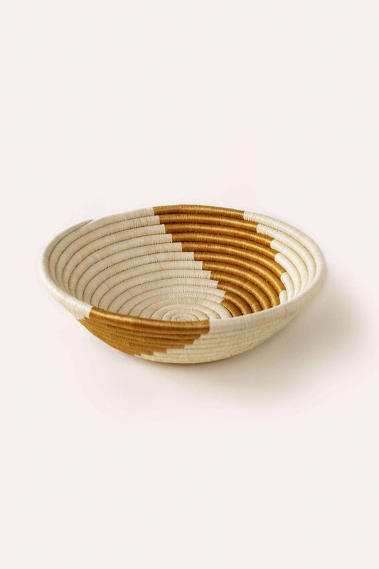 Woven basket with a two-tone pattern on a white background