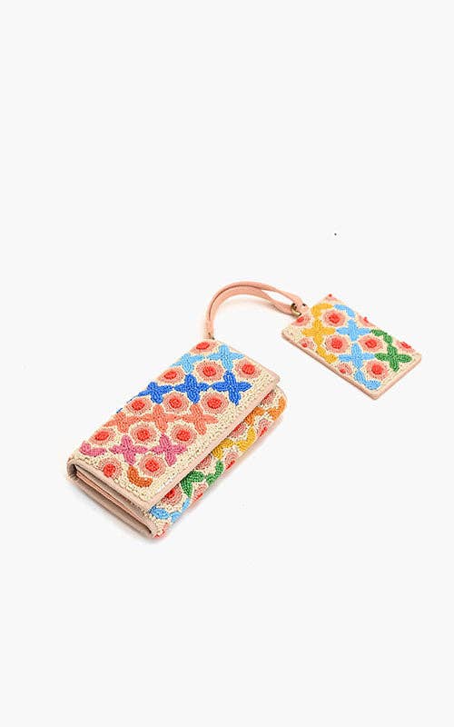 Colorful floral-patterned wallet and keychain on a white background