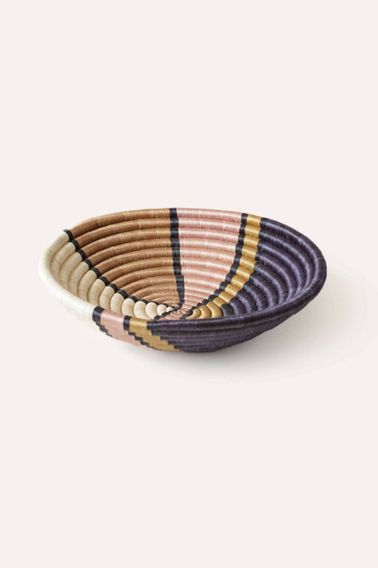 Woven basket with striped pattern on a white background