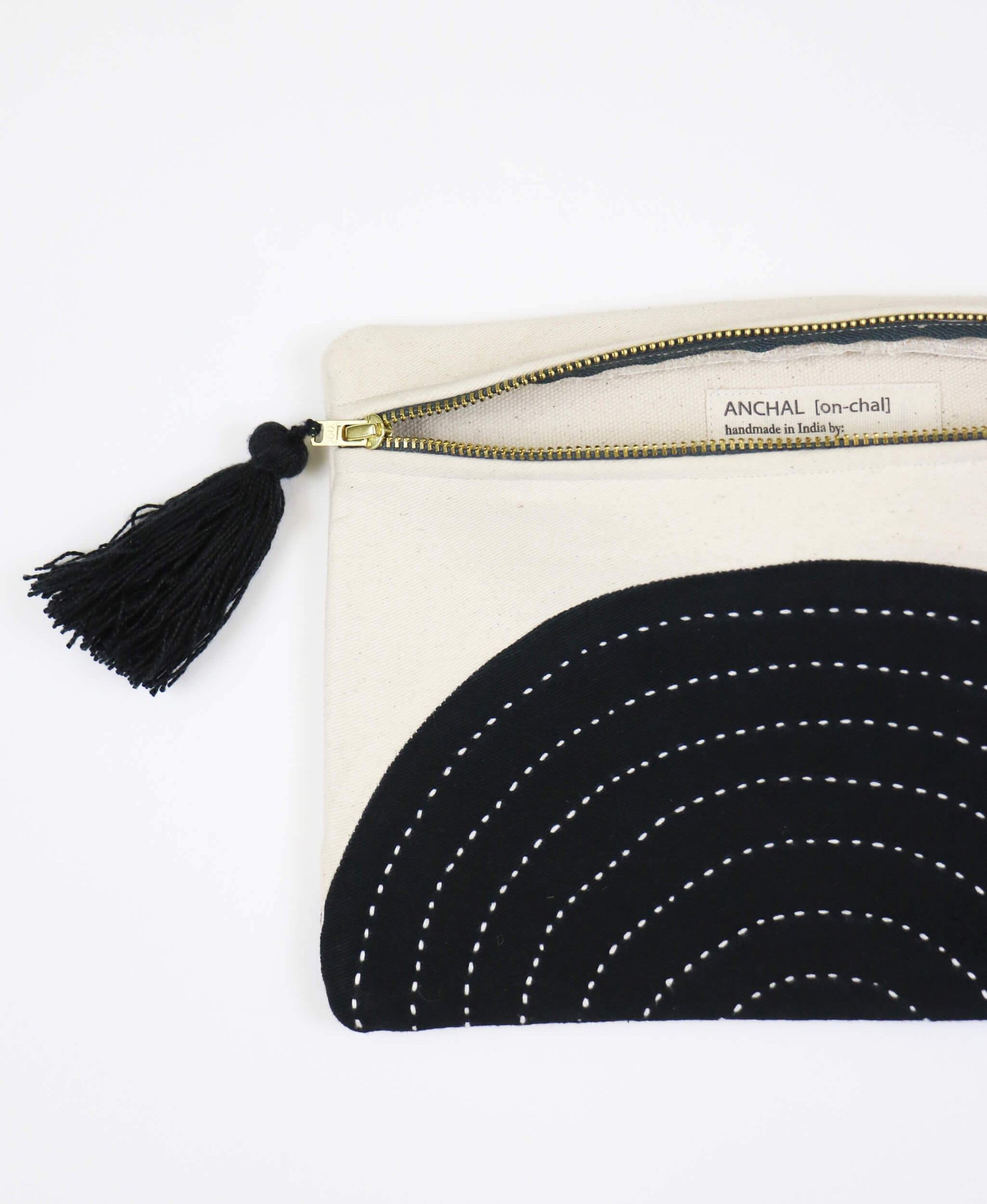 Black and white pouch with tassel on a white background