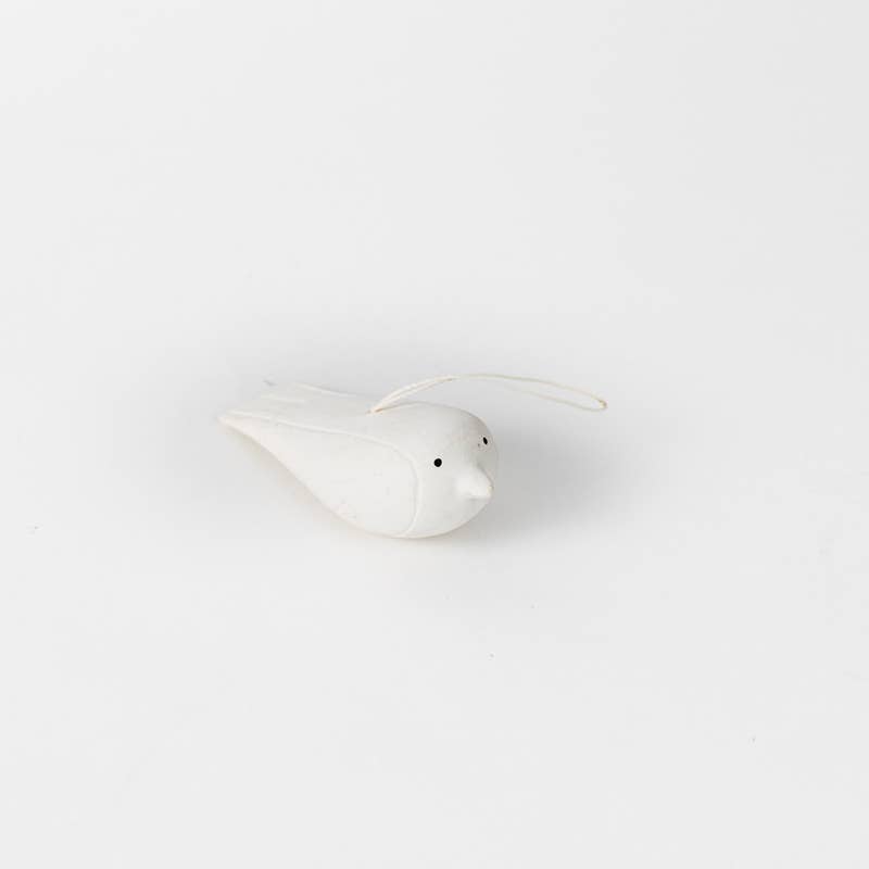 White ceramic bird-shaped object on a white background