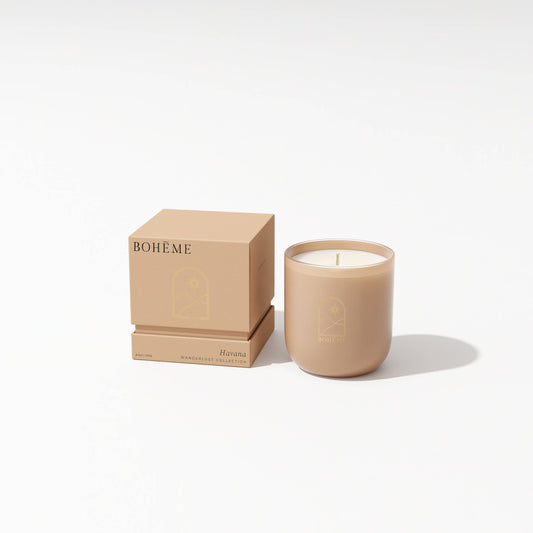 Beige candle with matching packaging on a white background