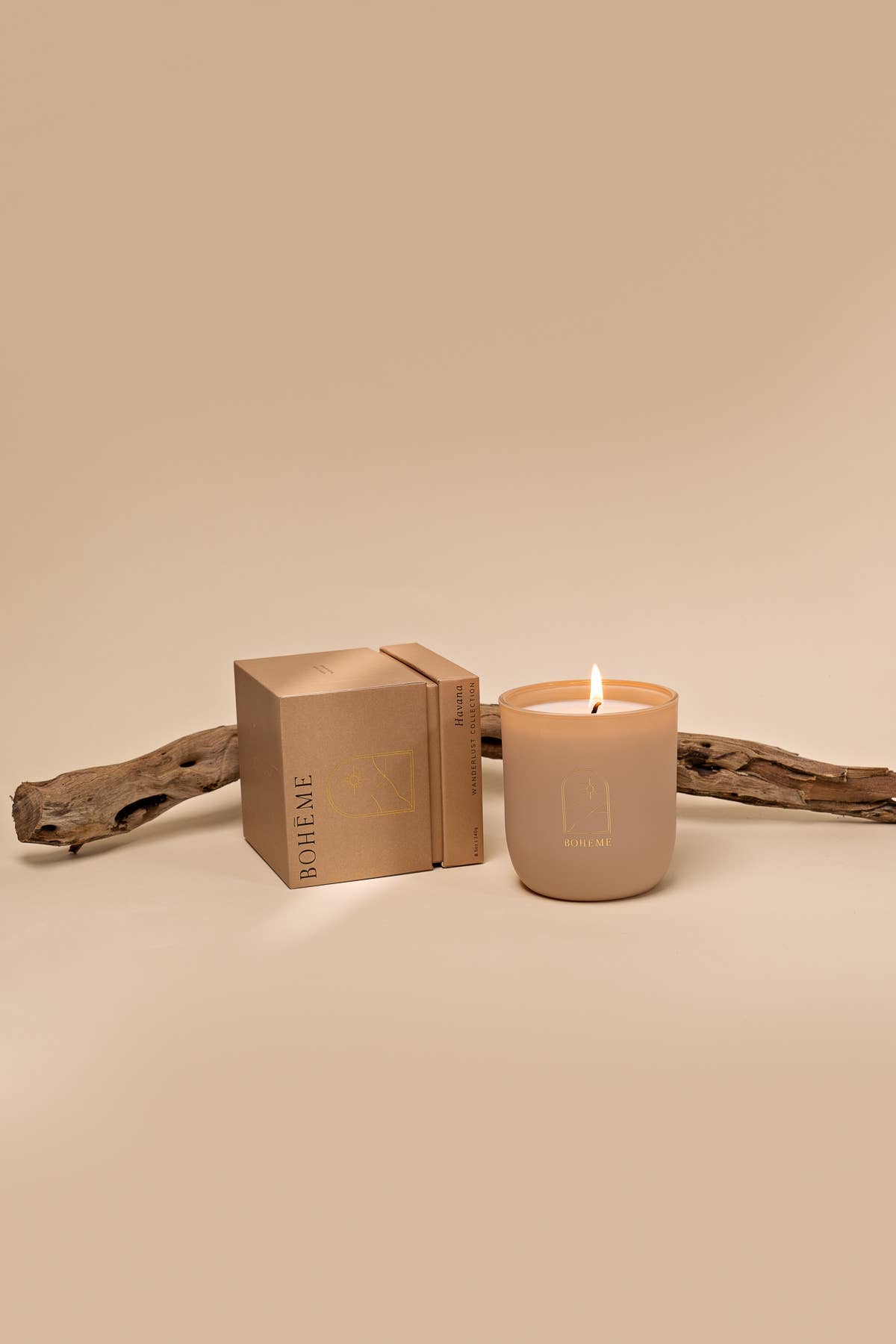 Beige candle with a matching box on a beige background