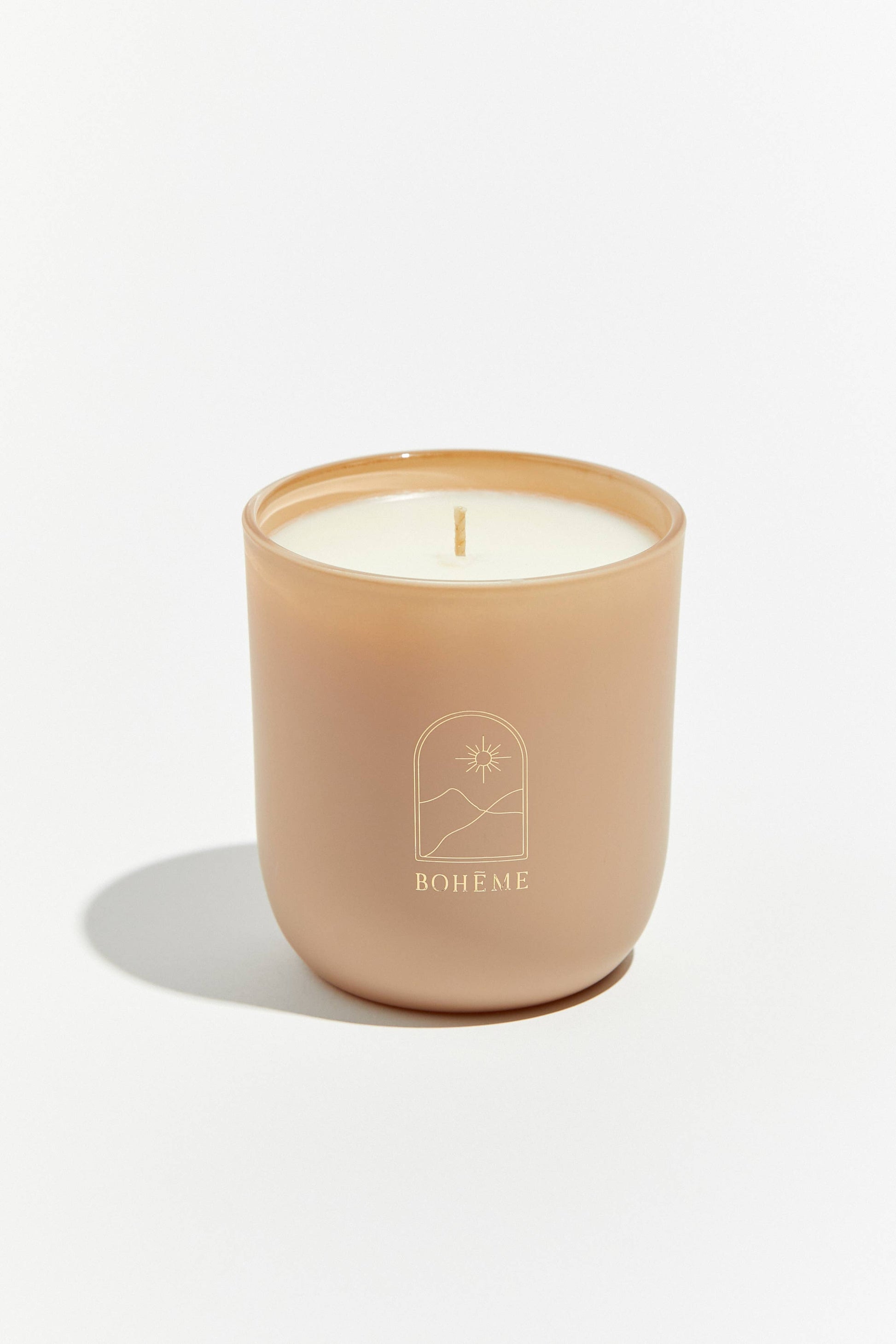 Candle in a beige holder with 'Boheme' branding on a white background