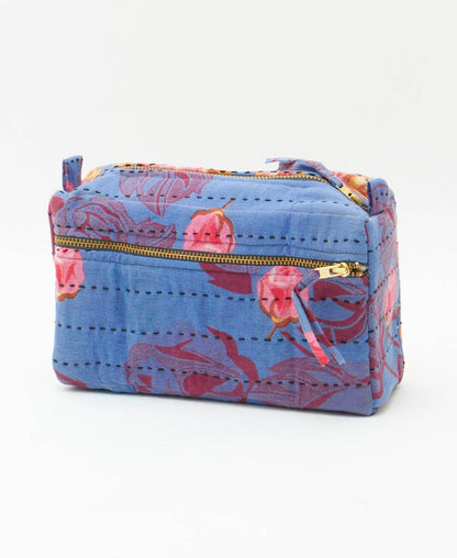 Blue pouch with floral pattern and gold zipper on a white background