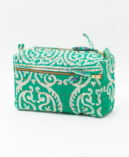 Green and white patterned pouch with a gold zipper on a white background