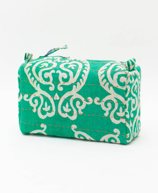 Green fabric pouch with white floral pattern on a white background