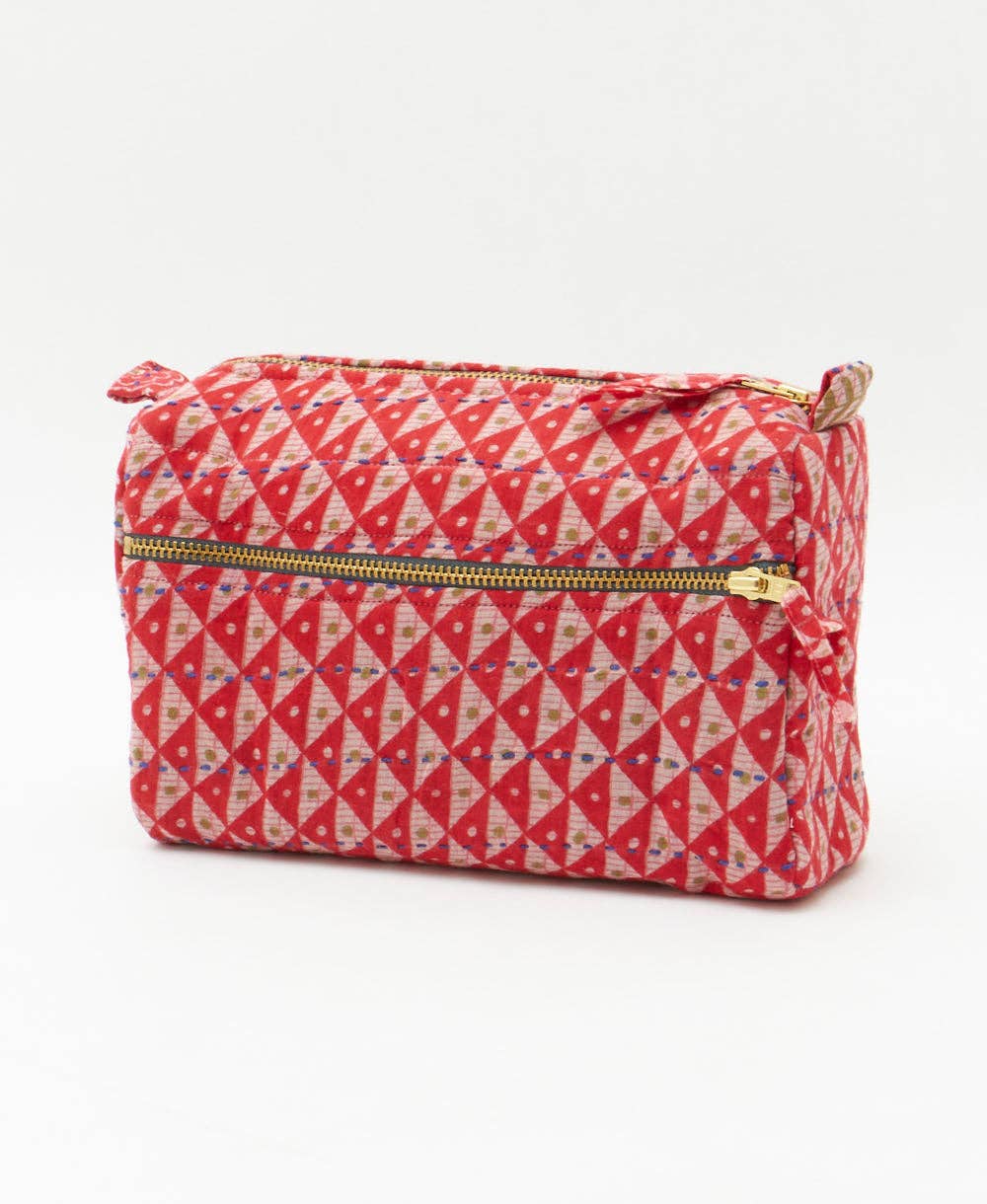Red and white geometric patterned pouch with a zipper on a white background