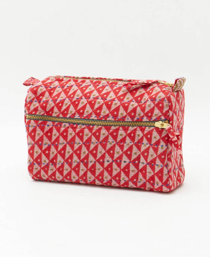 Red and white geometric patterned pouch with a zipper on a white background