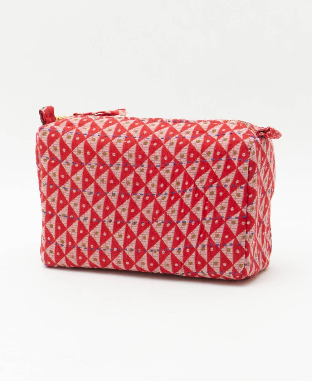 Red and beige patterned toiletry bag on a white background
