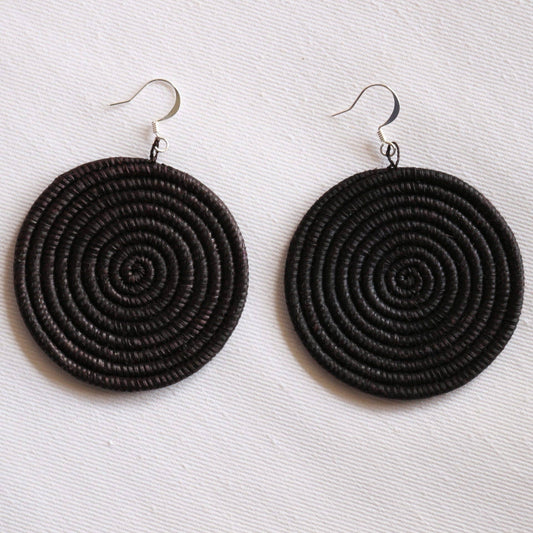 Black spiral earrings on a white background