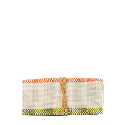 Foldable jewelry roll with colorful border and brown strap on a white background