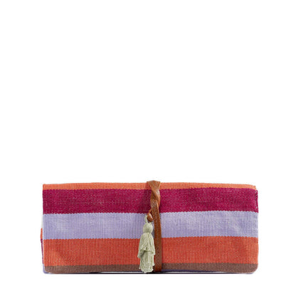 Striped clutch bag with a tassel on a white background