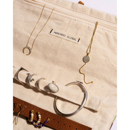 Jewelry set including necklaces, bracelets, and earrings on a Mercado Global branded pouch.