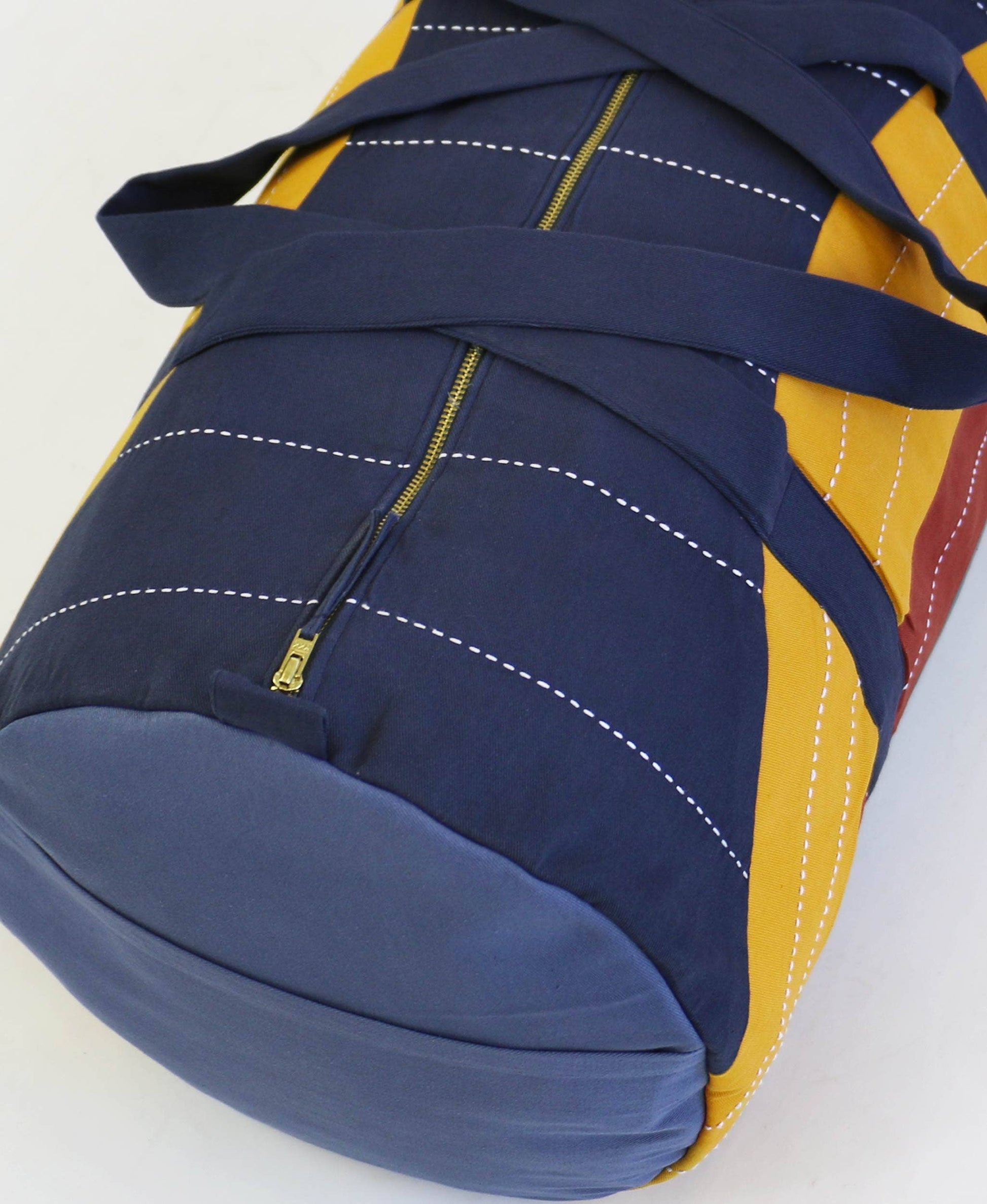 Blue and yellow backpack with a visible zipper on a white background