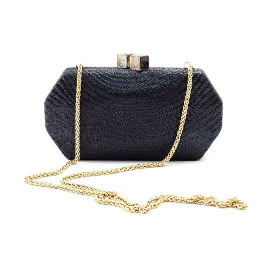 Black clutch bag with gold chain on a white background