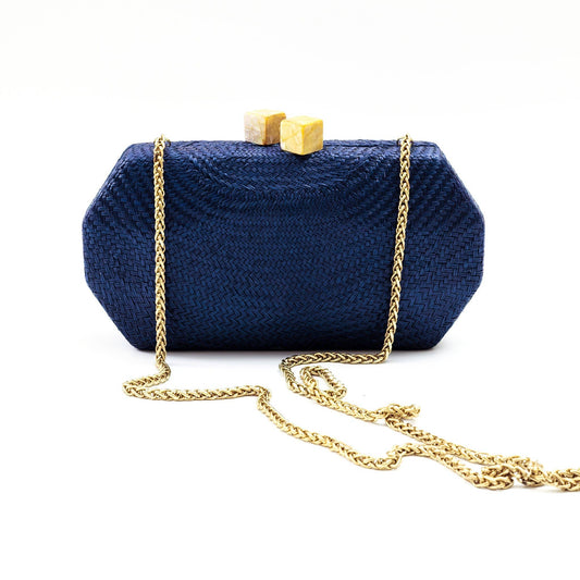 Navy blue clutch bag with gold chain on a white background