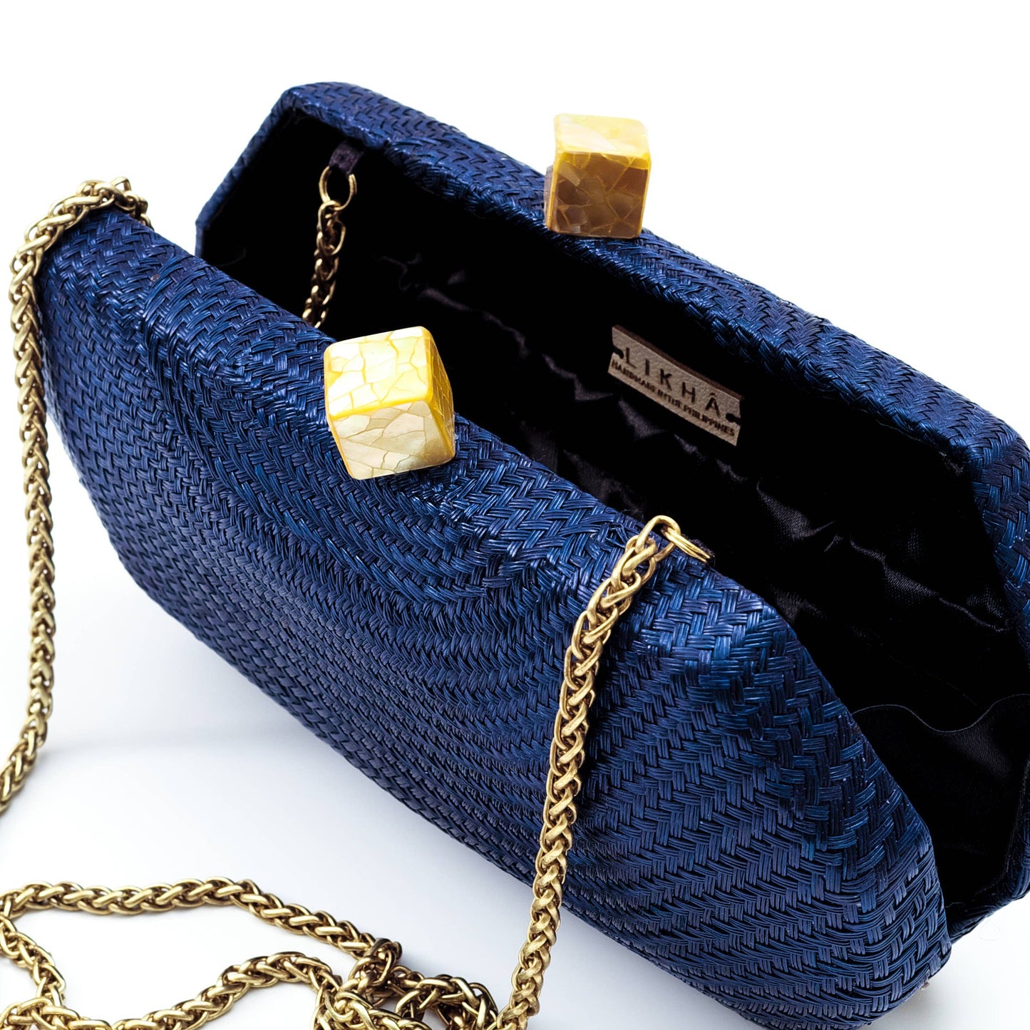 Blue clutch bag with gold chain and accents on a white background