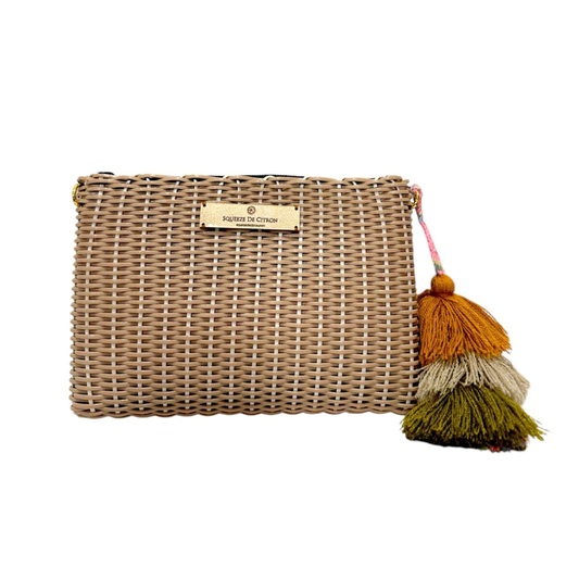 Woven clutch bag with tassel on a white background