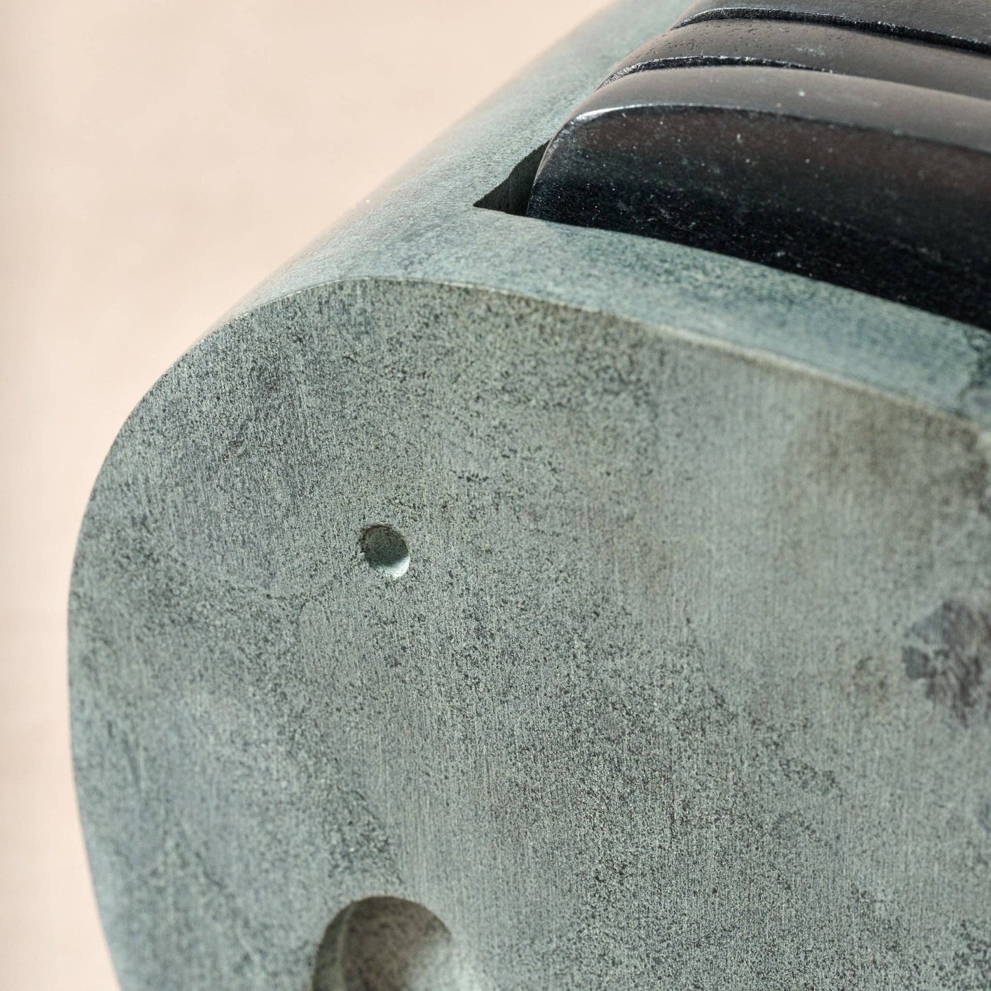 Close-up of a textured stone object with a beige background