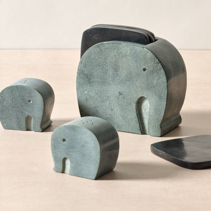 Set of stone elephant sculptures on a beige background