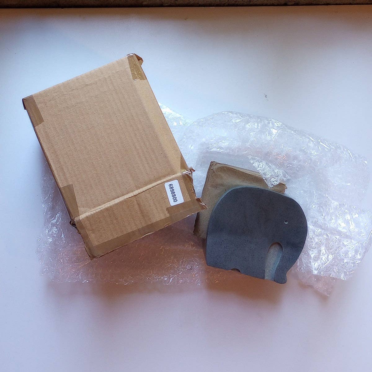 Cardboard box with a product on a white surface