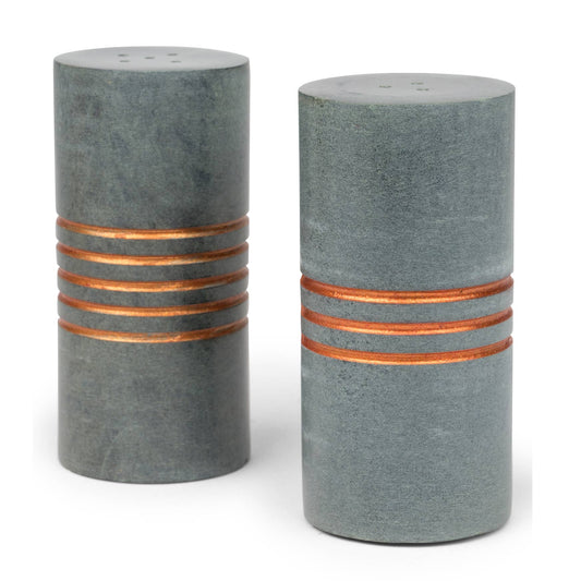 Two cylindrical salt and pepper shakers with copper bands on a white background