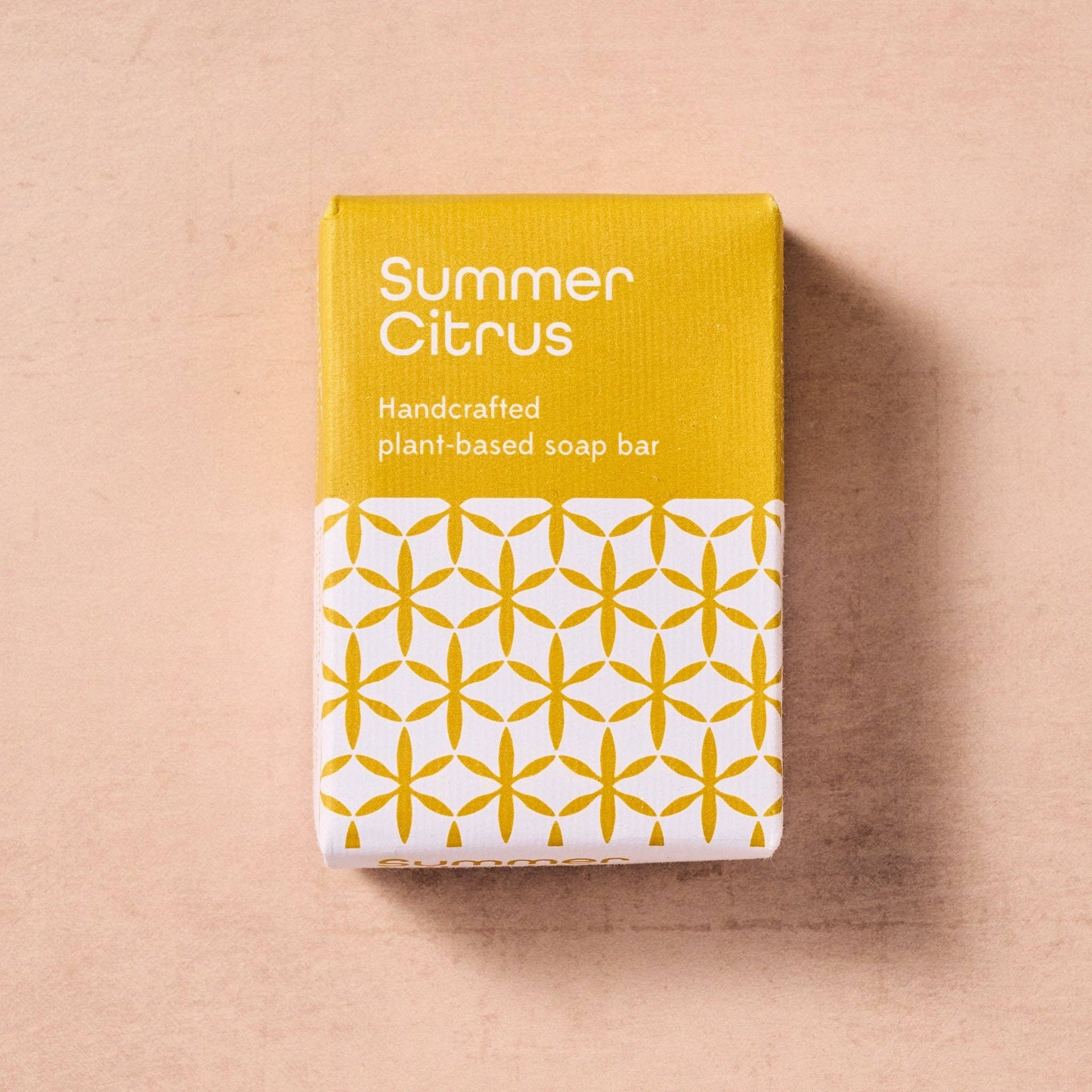 Handcrafted plant-based soap bar packaging with 'Summer Citrus' text on a beige background