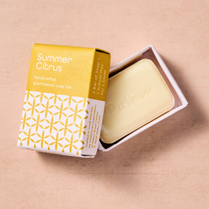 Bar of soap with 'Summer Citrus' packaging on a beige background