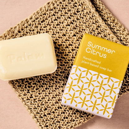 Bar of soap and packaging labeled 'Summer Citrus' on a textured surface