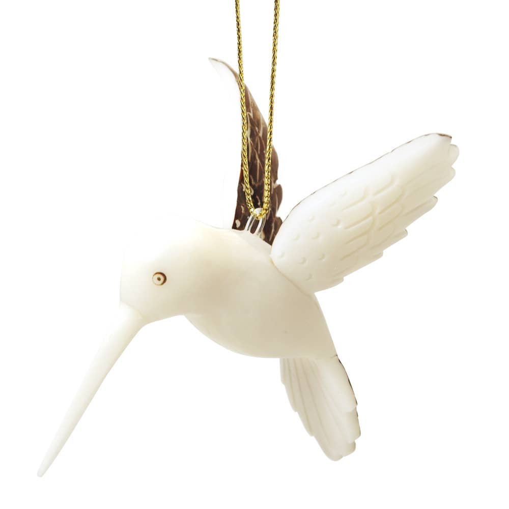 White hummingbird ornament with gold accents on a white background