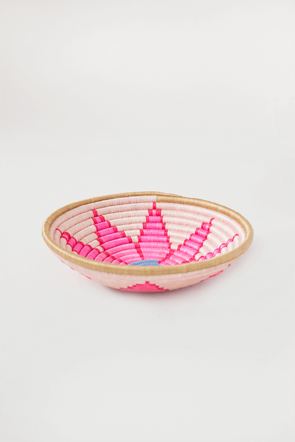 Woven basket with pink and red pattern on a white background