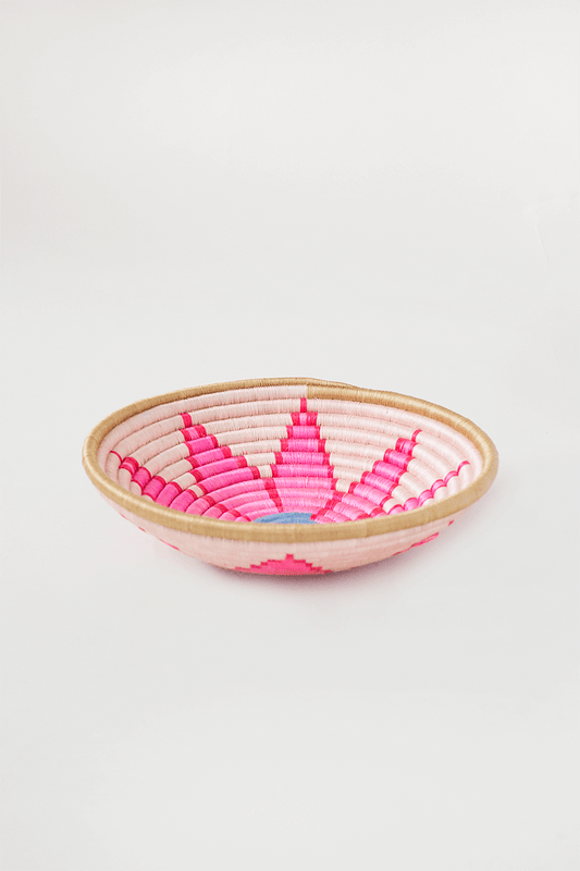Woven basket with pink and red pattern on a white background