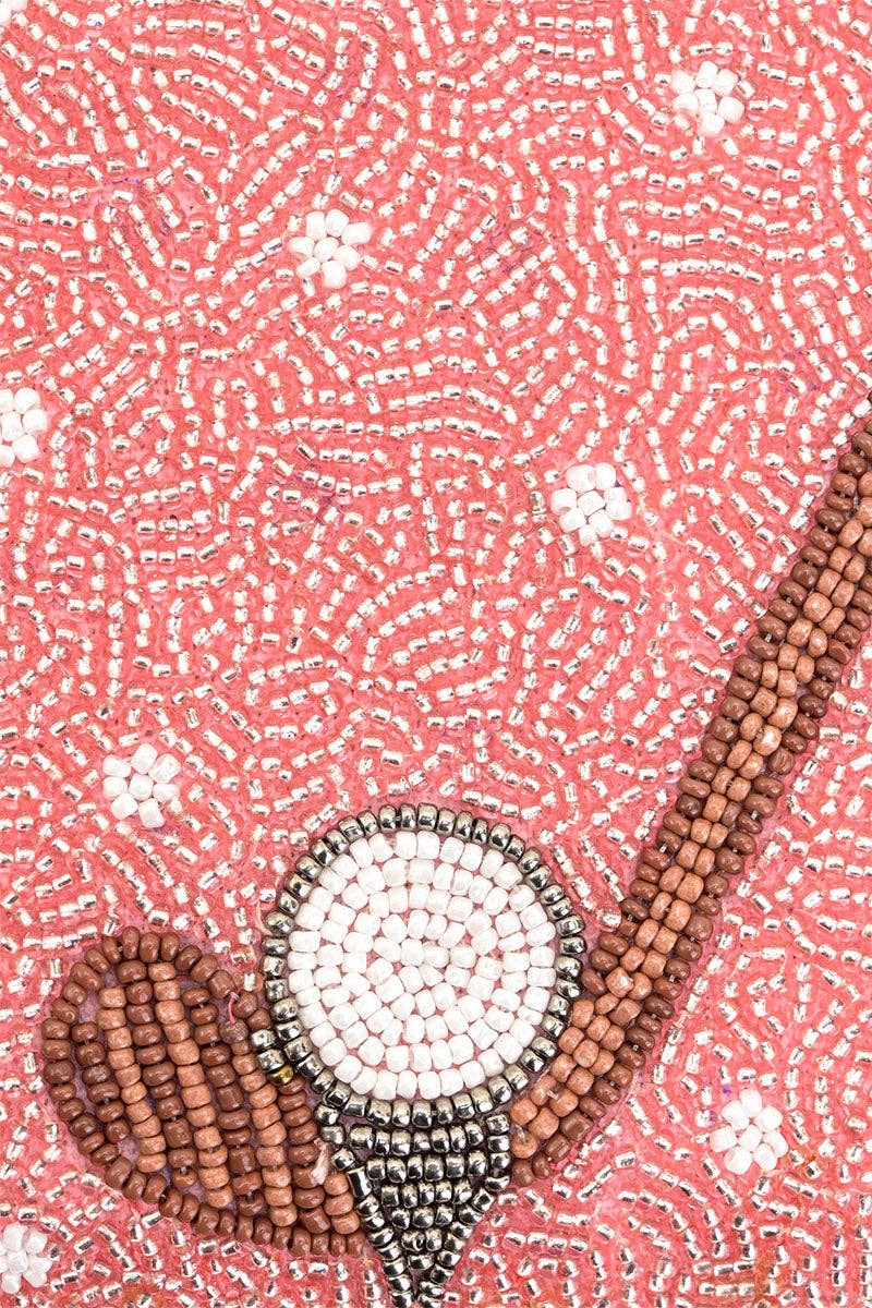 Decorative item with beads on a pink textured background