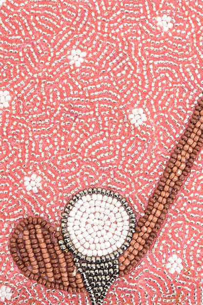 Decorative item with beads on a pink textured background