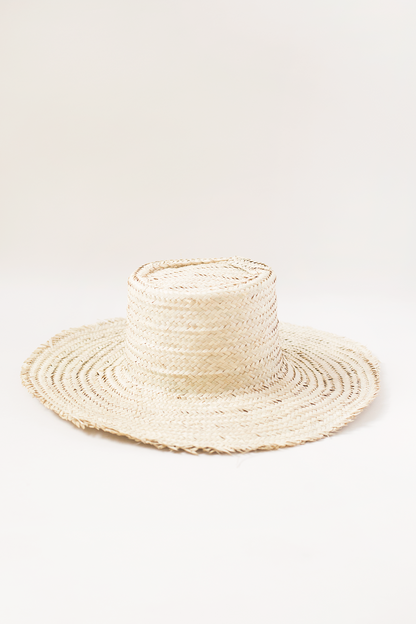 Beige straw hat on a white background