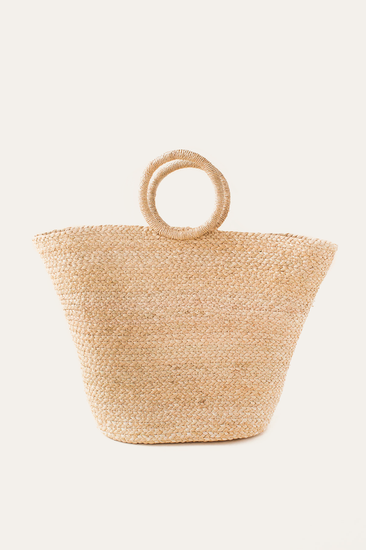 Beige woven bag with circular handles on a white background
