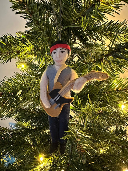 Ornament of a person playing guitar on a Christmas tree