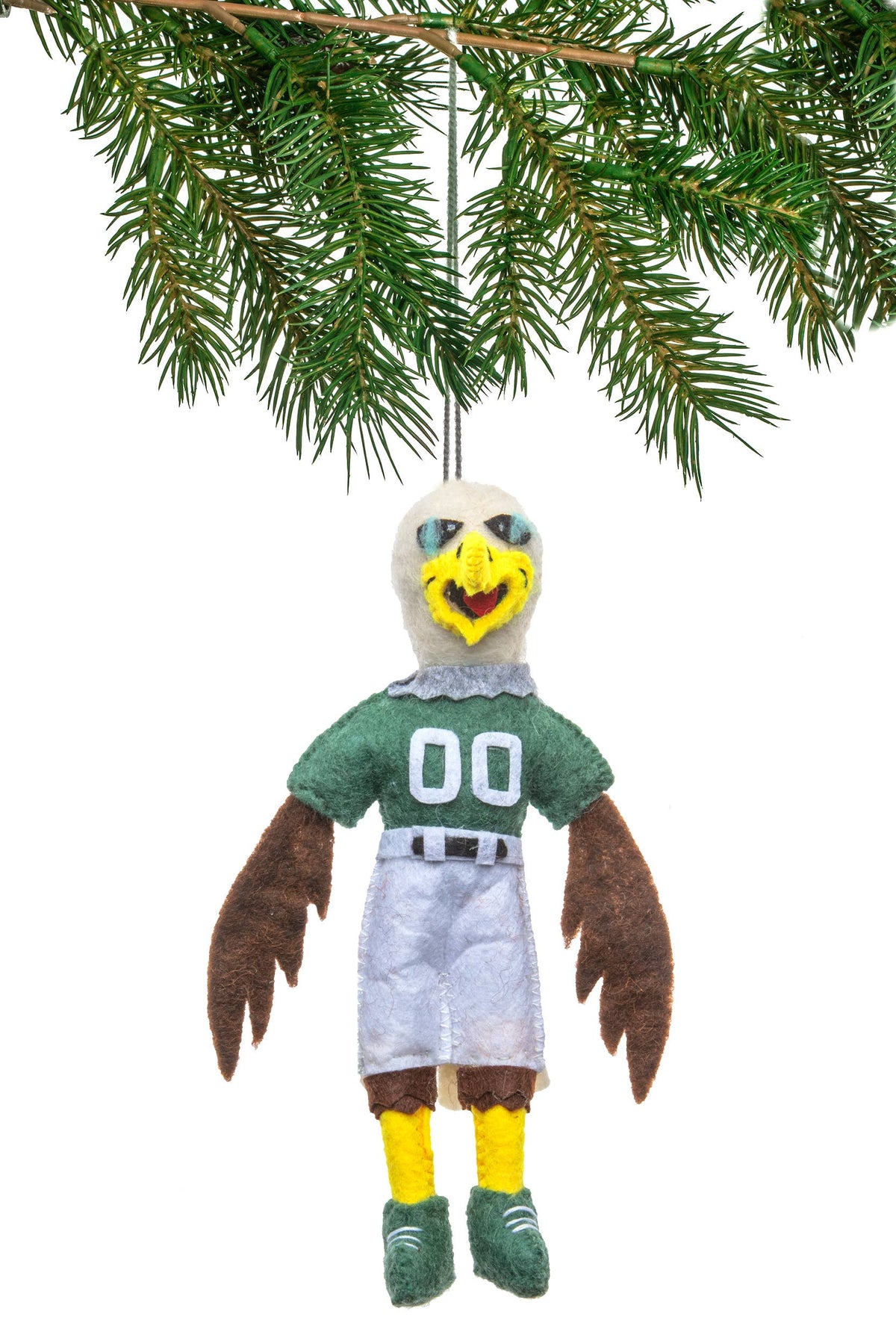 Plush eagle ornament in sports uniform hanging on a branch