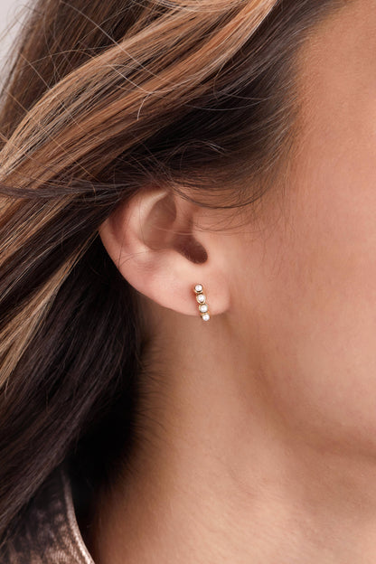 Close-up of an ear wearing a small earring 