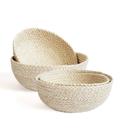 Set of four woven bowls on a white background