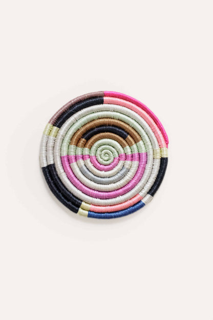 Colorful spiral-patterned coaster on a white background