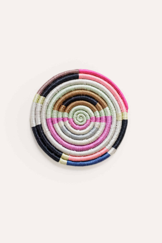 Colorful spiral-patterned coaster on a white background