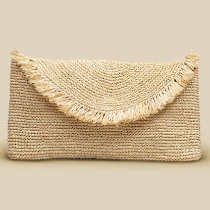 Woven clutch bag with frayed edges on a beige background