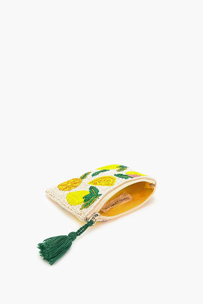Small pouch with lemon design and green tassel on a white background