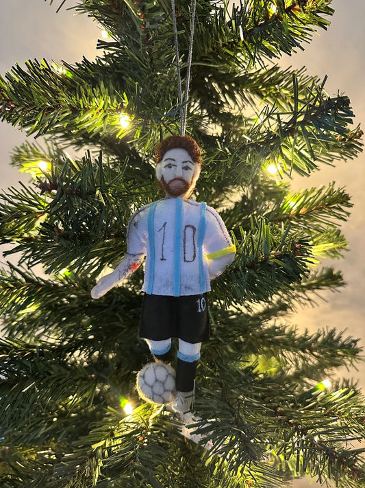 Soccer player ornament with number 10 on a lit Christmas tree