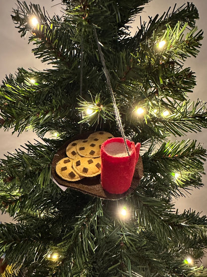 Christmas tree ornament with a red boot and cookies hanging from a string.